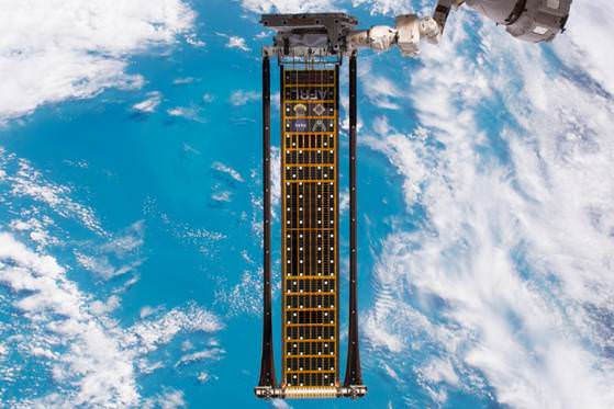 The Roll-Out Solar Array Attached to a Robotic Arm of the ISS