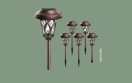 GIGALUMI Solar Pathway Lights illuminating a garden walkway at night with warm LED glow.