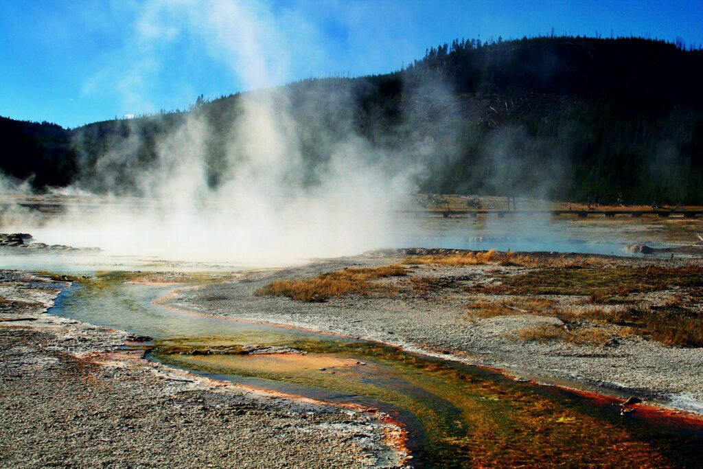Steam rises from a geothermal geyser in Yellowstone National Park, capturing nature's raw power.