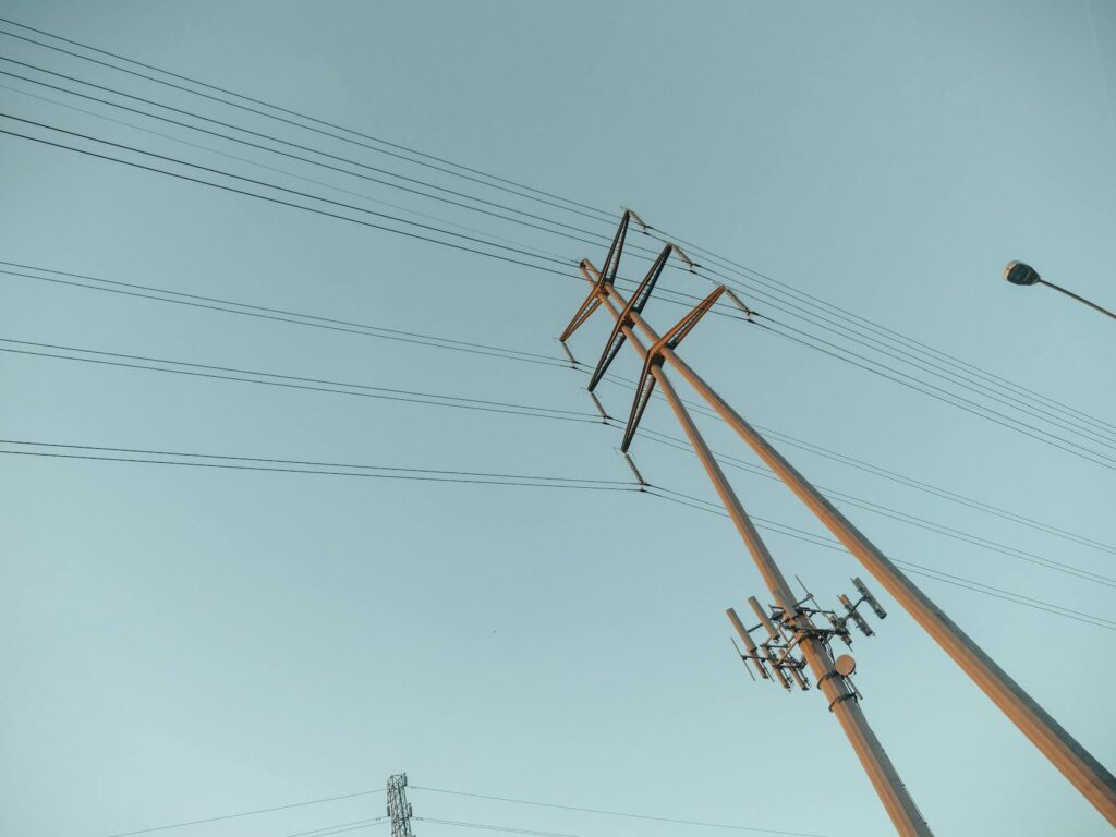 A captivating view of power lines stretching into the clear sky during sunrise, symbolizing energy and connectivity.