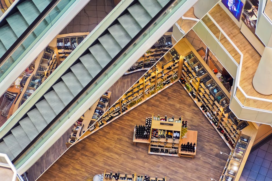 Aerial view of a stylish shopping mall showcasing escalators and well-organized retail displays.